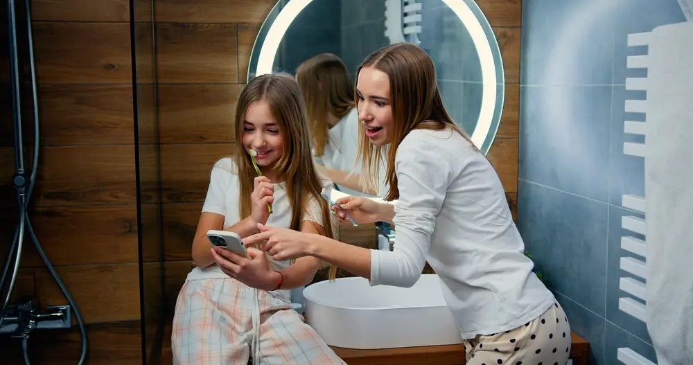 teen girls brushing teeth