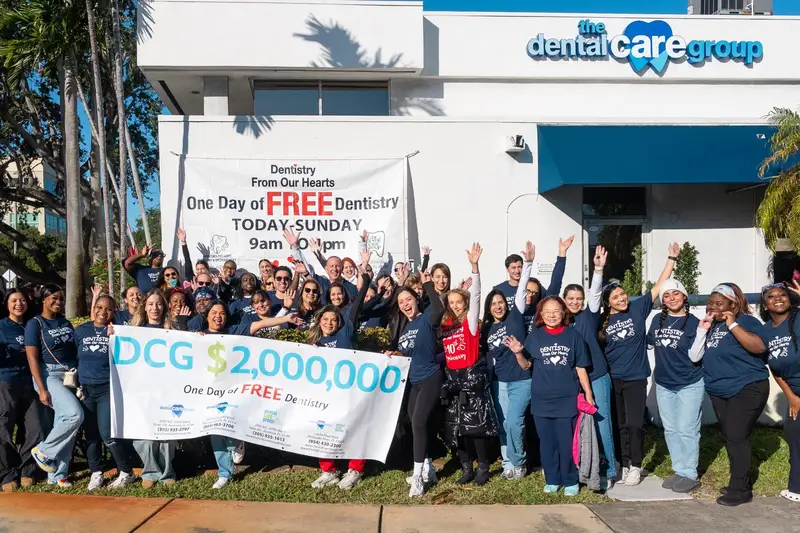 The team holding the One Day of Free Dentistry banner