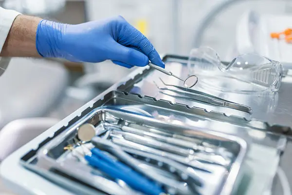dentist using a variety of dental tools during treatment
