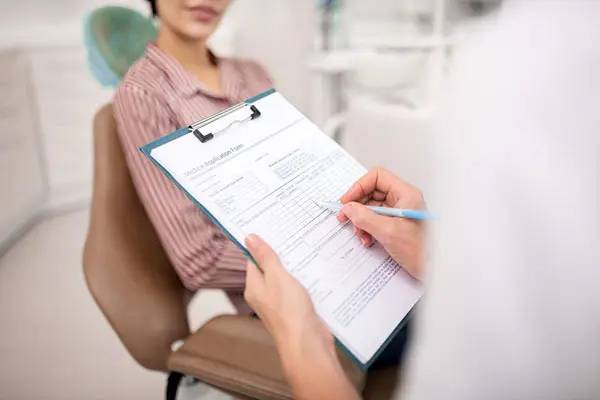patient and dentist going over patient forms