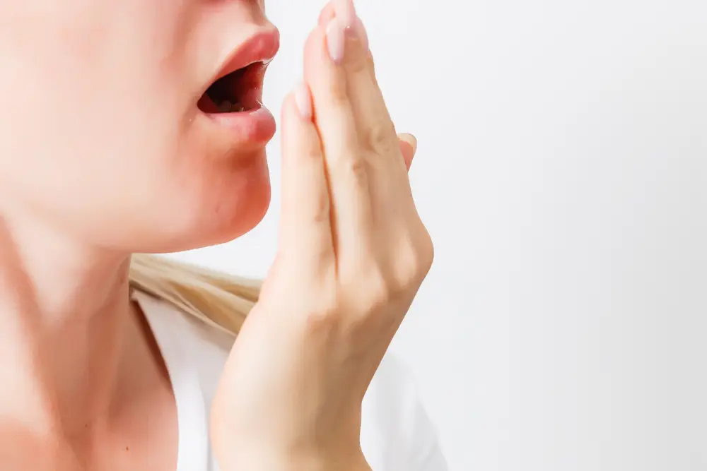 woman doing a test on her hand to check for bad breath