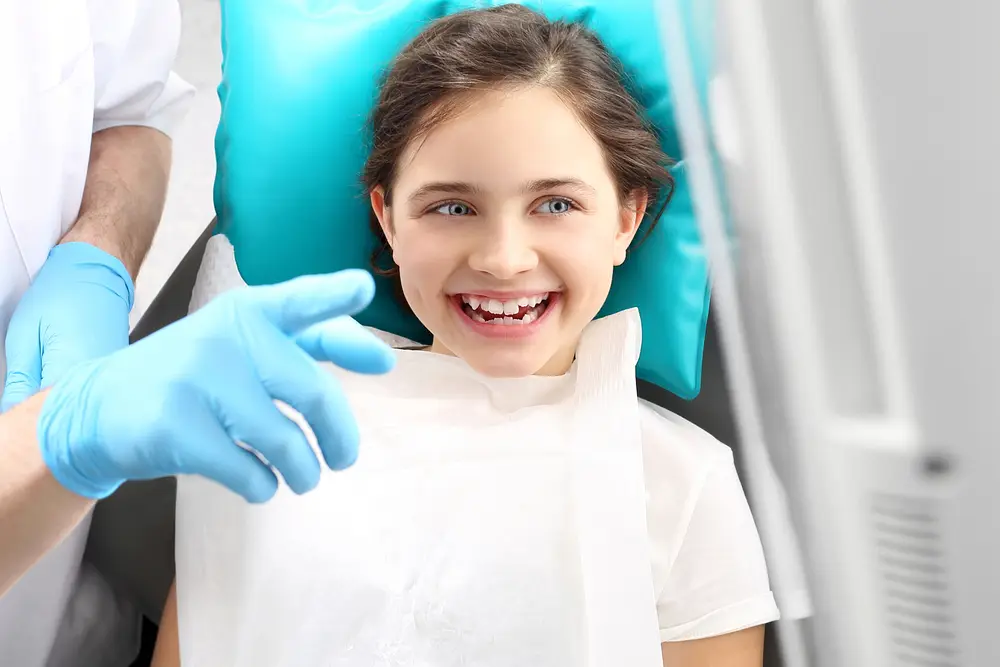 Smiling girl in the dental chair during a checkup
